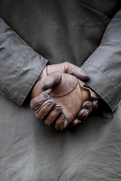 Person wearing leather gloves