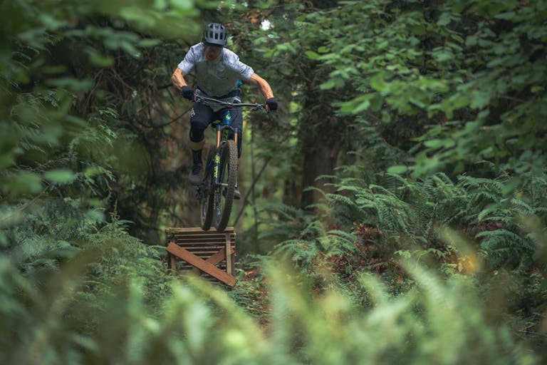 Bike Drop A man jumping a mountain bike off a ramp in the woods of Hood River, Oregon